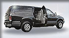 Black SUV with open rear door.