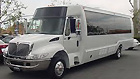 White passenger bus parked on the street.